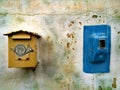 Old yellow postal box and blue electricity meter on a colourful wall, Monemvasia, Greece