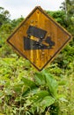 Old yellow rusted steep grade hill traffic sign.