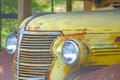 Old yellow rusty Chevrolet pickup truck grille and headlight Royalty Free Stock Photo