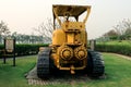 Old yellow rusty crawler tractor in the field. Old crawler tractor on green garden Royalty Free Stock Photo