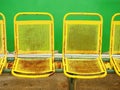 Old yellow rusty metal seats on outdoor stadium. Players bench chairs Royalty Free Stock Photo