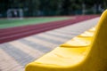 Old yellow seats in the stadium. Sport background Royalty Free Stock Photo