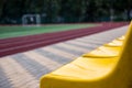 Old yellow seats in the stadium. Sport background Royalty Free Stock Photo