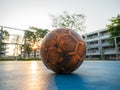 Old yellow soccer ball on the blue football field Royalty Free Stock Photo