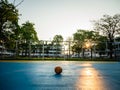 Old yellow soccer ball on the blue football field Royalty Free Stock Photo