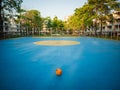 Old yellow soccer ball on the blue football field Royalty Free Stock Photo