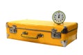 Old yellow suitcase with green alarm clock
