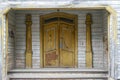Old yellow timber doors with columns