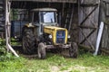 Old yellow tractor inside garage