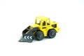 Old yellow tractor toy on white background