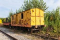 Old yellow train with big holes, rusty and abandoned in the field Royalty Free Stock Photo