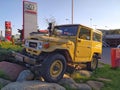 Old yellow vintage historic first Toyota Land Cruiser all road car on rocks