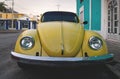 Old yellow Volkswagen beetle in the colonial streets of Merida, Yucatan, Mexico
