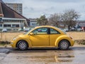 Old yellow Volkswagen New Beetle parked