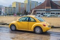 Old yellow small veteran car Volkswagen New Beetle parked Royalty Free Stock Photo
