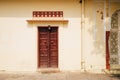 Old yellow wall and wooden door at City Palace in Jaipur, India Royalty Free Stock Photo