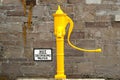 Old yellow water pump in Macroom square Ireland