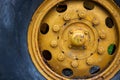 Old yellow wheel with black tire, rustic heavy machine detail photo. Working Tractor or grader detail Royalty Free Stock Photo