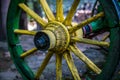 Old yellow wooden wheel of wagon Royalty Free Stock Photo