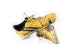 Old yellow worn out futsal sports shoes on white background soccer sportware object isolated Royalty Free Stock Photo