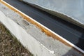 Old yellowed mounting foam under a large terrace window, visible styrofoam insulating the foundations of the house. Royalty Free Stock Photo