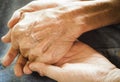 Old and young female holding hands . People, care and support. Giving helping hand concept .The concept of care and help for old Royalty Free Stock Photo