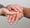 Old and young hand with walking stick Royalty Free Stock Photo