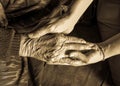 Old and young hands check hand sepia tone