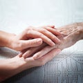 Old and young holding hands on light background, closeup. Care is at home of elderly