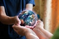 old and young person hands holding planet earth, unity concept. elements of this images furnished by nasa