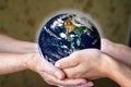 old and young person hands holding planet earth, unity concept. elements of this images furnished by nasa