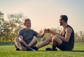 The old and young sportsmen greeting on the grass. Royalty Free Stock Photo