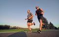 The old and young sportsmen running on the alley.