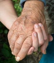 Old and young woman holding hands together Royalty Free Stock Photo