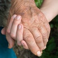 Old and young woman holding hands together Royalty Free Stock Photo