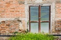 Old zinc gate with old bricks wall and grass background Royalty Free Stock Photo