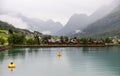 Olden, Norway-July 18, 2023: Foggy shoreline of Olden. A quiet village on the Oldener Fjord, shrouded in morning mist Royalty Free Stock Photo