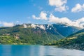 Olden, Norway, typical summer panorama of Norwegian village landscape, mountains and colorful traditional nordic houses