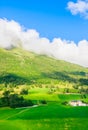 Olden, Norway, typical summer panorama of Norwegian village landscape, mountains and colorful traditional nordic houses