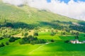 Olden, Norway, typical summer panorama of Norwegian village landscape, mountains and colorful traditional nordic houses