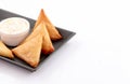 Olden samosa stuffed in black sizzling plate on white background