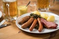 Oldenburger green cabbage with sausage mix, Kassler pork neck, boiled potatoes, mustard, beer and grain liquor is an traditional Royalty Free Stock Photo