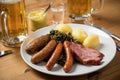 Oldenburger green cabbage with sausage mix, Kassler pork neck, boiled potatoes, mustard, beer and grain liquor is an traditional Royalty Free Stock Photo