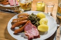 Oldenburger green cabbage with sausage mix, Kassler pork neck, boiled potatoes, mustard, beer and grain liquor is an traditional Royalty Free Stock Photo