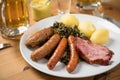 Oldenburger green cabbage with sausage mix, Kassler pork neck, boiled potatoes, mustard, beer and grain liquor is an traditional Royalty Free Stock Photo