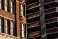 Older architectural red brick and stone office building next to tall modern office building Royalty Free Stock Photo