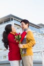 Older asian couple on balcony with roses Royalty Free Stock Photo