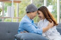 Older Asian woman patient covered the head with clothes effect from chemo treatment in cancer cure process touch her daughter`s