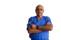 Older bald serious senior doctor with his arms folded, holding his stethoscope isolated on a white background Royalty Free Stock Photo