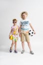 An older brother with a ball and a younger sister. Boy and girl are holding hands Royalty Free Stock Photo